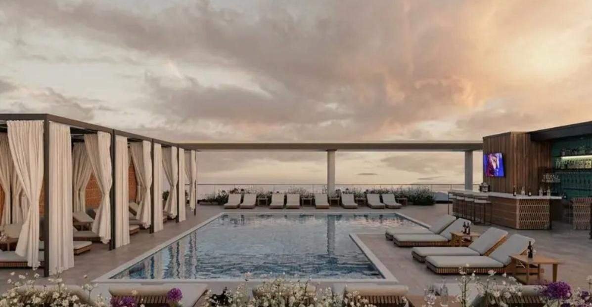 Rooftop pool and cabanas at sunset